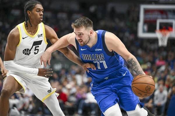 Dallas Mavericks guard Luka Doncic (77) drives against Utah Jazz forward Cody Williams.
