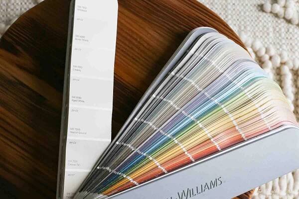 sherwin williams paint chip book open to SW 7012 - Creamy on a wood tray
