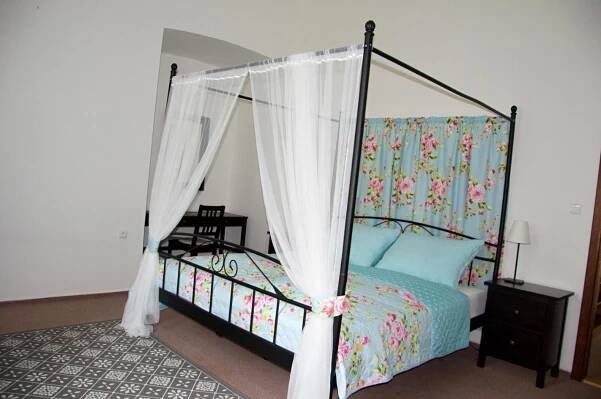 a bedroom with a bed with a canopy at Penzion Zámek Rozsochatec in Rozsochatec