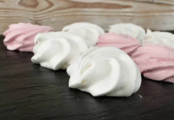 Bílé a růžové koláčky s meringue. Tradiční whisky merengues, pečené whisky krém nebo beze na rozmazaném pozadí — Stock obrázek