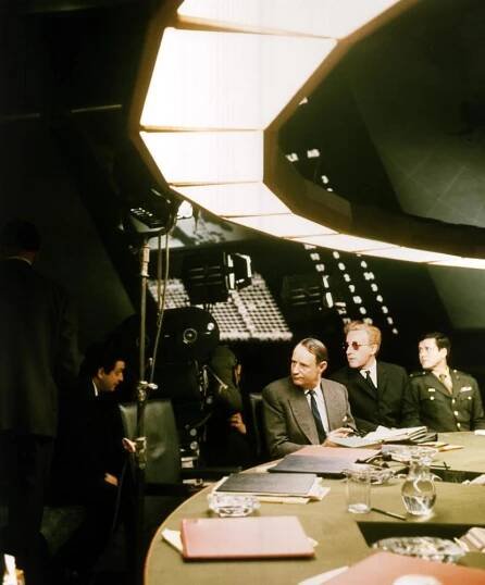 DR. STRANGELOVE, (aka DR. STRANGELOVE OR: HOW I LEARNED TO STOP WORRYING AND LOVE THE BOMB), Director Stanley Kubrick with Peter Sellers, on set, 1964