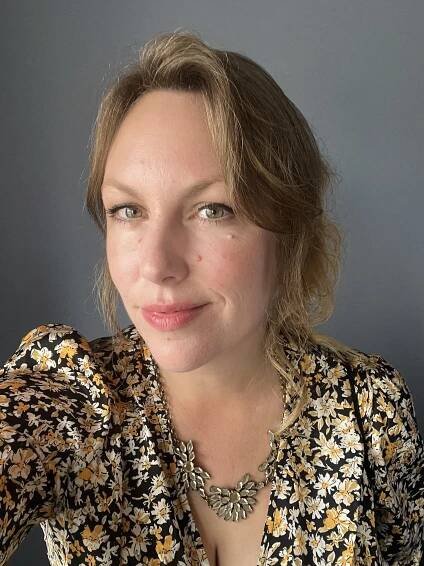 Headshot of Michelle Morgan Davies wearing a floral blouse and necklace.