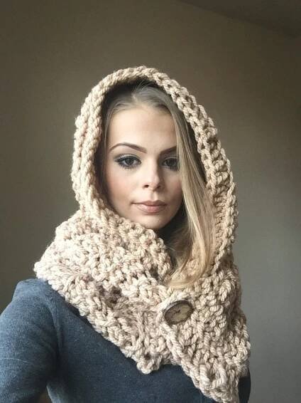 a woman wearing a knitted cowl with a hood on it's head