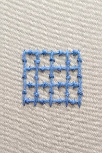 A square grid worked with horizontal and vertical lines of coral stitch.