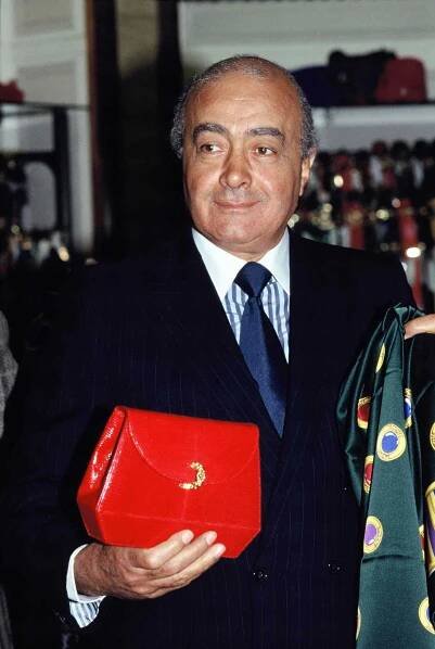 Egyptian businessman Mohamed Al Fayed with a bag designed by Paloma Picasso in 1989