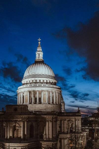 Free A breathtaking view of St Paul's Cathedral in London during the evening with a deep blue sky. Stock Photo