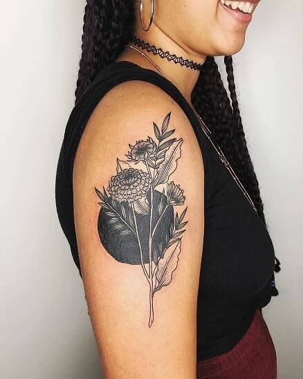 a woman with a flower tattoo on her arm