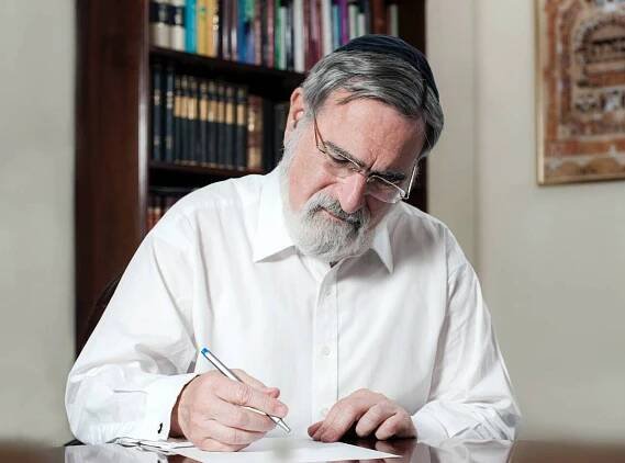 rabbi sacks author pen writing desk notes signature paper table signing landscape edited