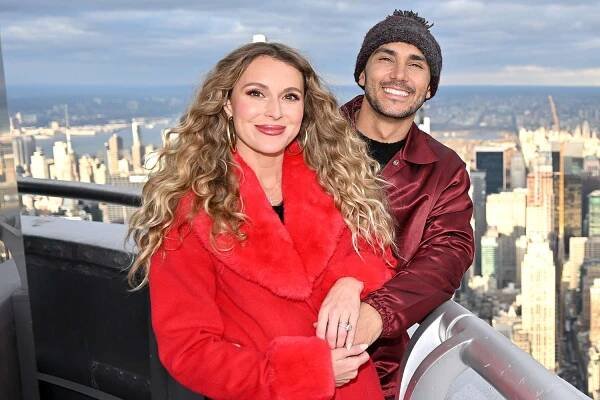 Alexa PenaVega and Carlos PenaVega light the Empire State Building in partnership with Salvation Army USA in honor of Red Kettle Kickoff at The Empire State Building on December 02, 2024 in New York City