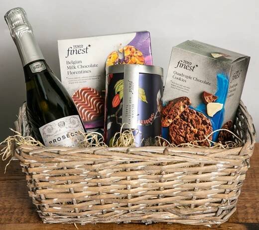 Tesco Finest Christmas hamper with prosecco, chocolates, and cookies.