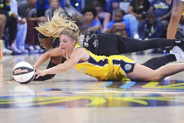 Sparks rookie guard Sarah Ashlee Barker and Dallas Wings guard Arike Ogunbowale fight for a loose ball 