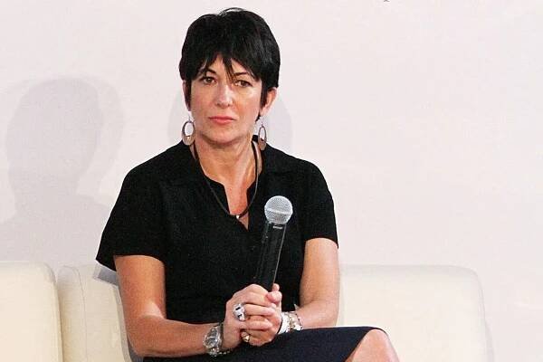 Ghislaine Maxwell sits on a white sofa holding a microphone.