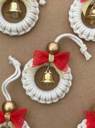 three bells with red bows are hanging on the wall