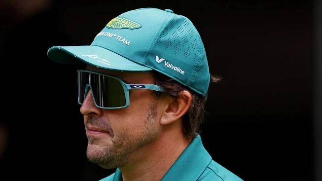 May 1, 2025; Miami Gardens, FL, USA; Aston Martin driver Fernando Alonso (14) walks in the paddock ahead of the F1 Miami Grand Prix at Miami International Autodrome. Mandatory Credit: Peter Casey-Imagn Images