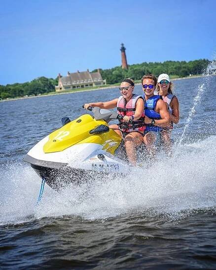 3 people having fun on a jetski