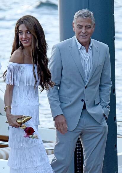 Amal Clooney in a fringed dress in Lake Como with George Clooney