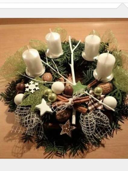 a christmas wreath with candles and decorations