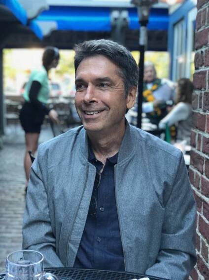 headshot of Jack Martin, member of the Digital Library Advisory Board, seated in a restaurant's outdoor patio