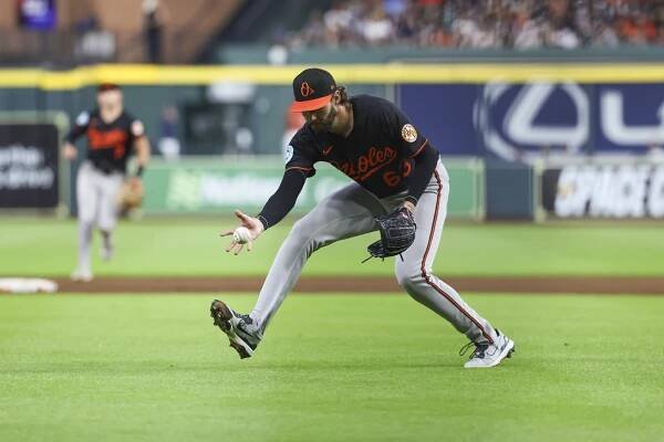 Baltimore Orioles pitcher Brandon Young fielding a ground ball.