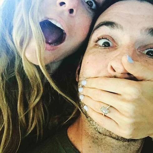 Tom Ellis and Meaghan Oppenheimer announce their engagement on Instagram.