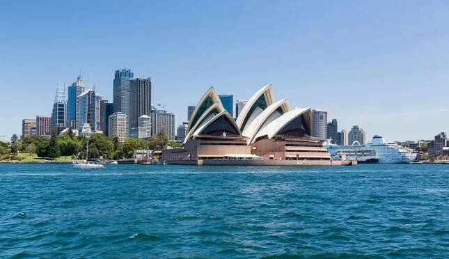 Central business district of city of Sydney with the Pacific Pearl Cruise ship docked in the harbour