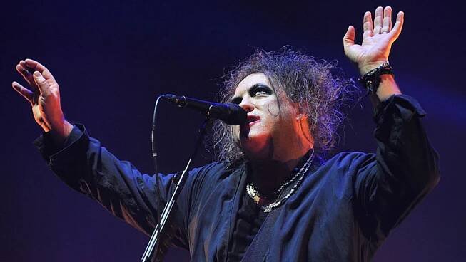 Robert Smith of The Cure performs live on stage at Wembley Arena on December 1, 2016 in London, England.