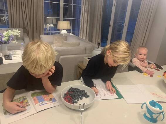 Holly Branson's children doing homework at the table