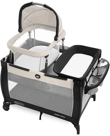 A baby crib with a white cover
