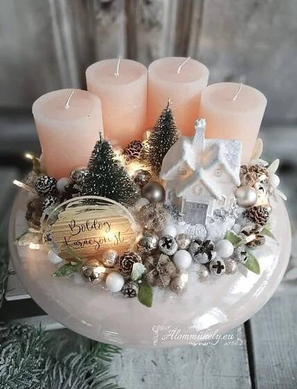 some candles are sitting in a bowl with christmas decorations on it and pine cones around them