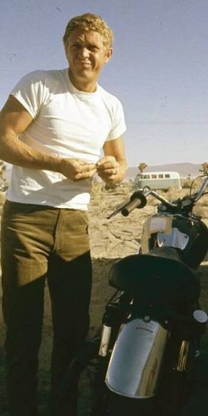 a man standing next to a parked motorcycle