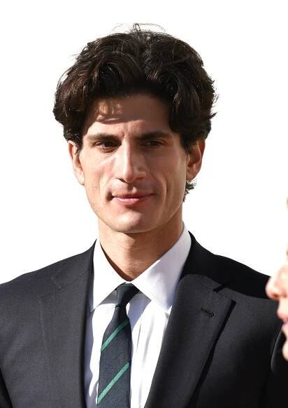 Jack Schlossberg in a suit with a striped tie
