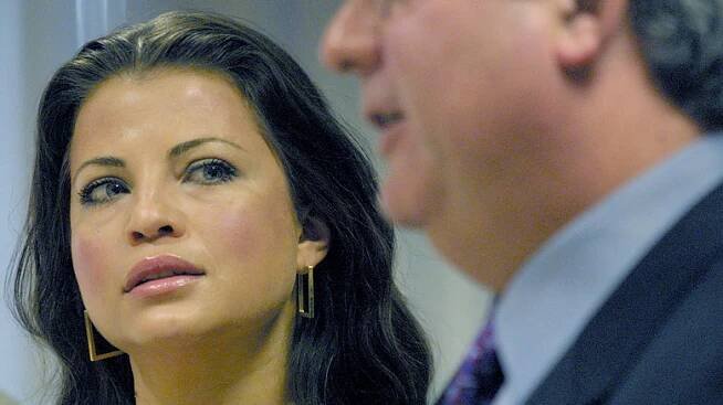 Yasmine Bleeth looking at lawyer