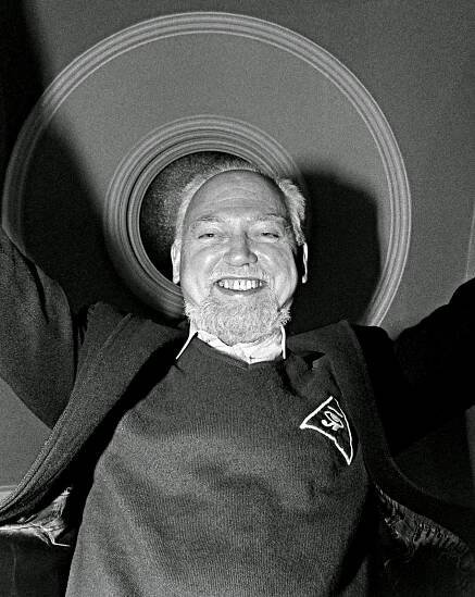 RAW outfitted in Illuminati regalia and demonstrating the Freemasonic sign of distress.