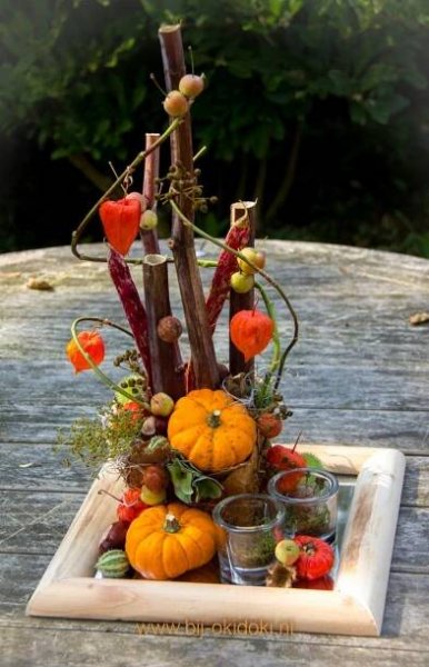 a wooden tray filled with lots of different types of fruits and vegetables on top of a table