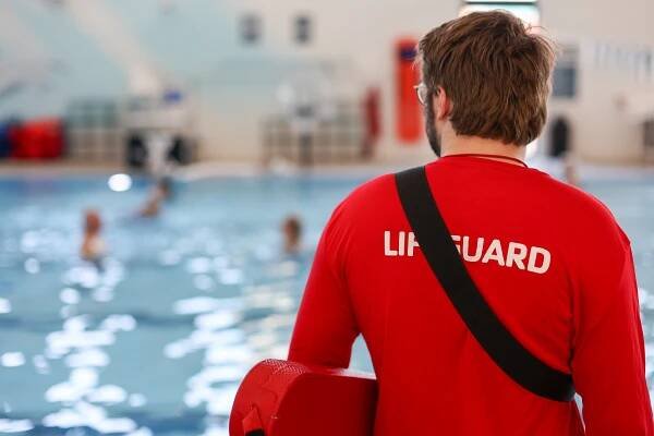 Y staff lifeguard watches over swimmers