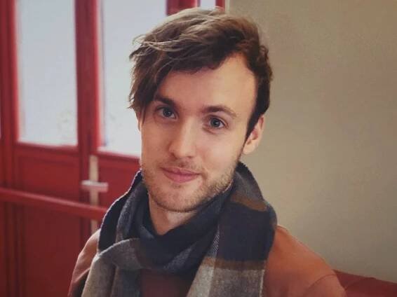 Henry St Leger headshot in a scarf