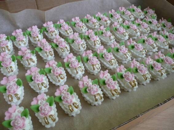 a box filled with lots of decorated cookies in the shape of flowers and skulls on top of each other