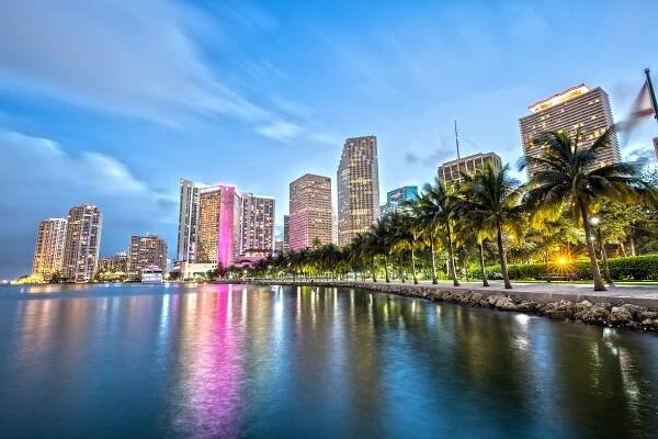 Downtown Miami skyline at dusk, viewed from across the water.