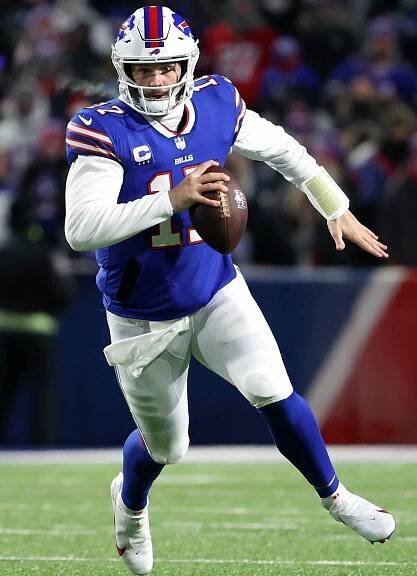 Josh Allen runs the ball for a first down against the New England Patriots during the first quarter in the AFC Wild Card playoff game on January 15, 2022 in Buffalo, New York. 