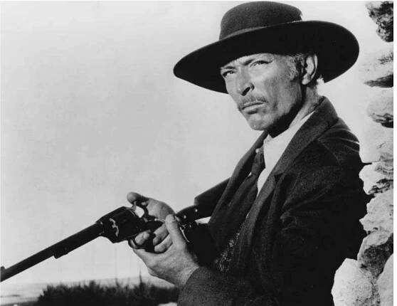 Colonel Douglas Mortimer and his Buntline Special: Lee Van Cleef makes his Italian western debut in For a Few Dollars More (1965).  own, you’ve seen ’em all’, took on much more significance.  Lee Van Cleef’s Colonel Douglas Mortimer isn’t a ‘whiter-than-white’ hero. In n interview, Van Cleef described the colonel as, ‘A non-angelic sort of character. vho’s still on the side of the law’, while Leone’s concept of the character was John carradine’s shady southern gambler Hatfield in John Ford’s Stagecoach (1939) lortimer is more ‘modern’ than Eastwood’s stranger: he keeps a little black book f bounties, opens the safe with special acid (rather than dynamite) and has ar rsenal of weapons wrapped in his saddlecloth. His sidearm is a Buntline Specia vith a 12-inch barrel and a detachable shoulder stock, which slows his draw — sc nuch so that we never see the colonel use it in a quick-draw duel. He leisurely hoots outlaw Callaway at distance, kills the Wild One with a Derringer from up is sleeve and borrows Manco’s pistol and gunbelt to face Indio. Van Cleef always 