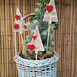 a basket filled with christmas trees on top of a table