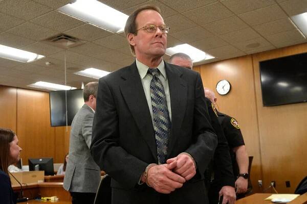 Mark Jensen is led out of the courtroom in handcuffs