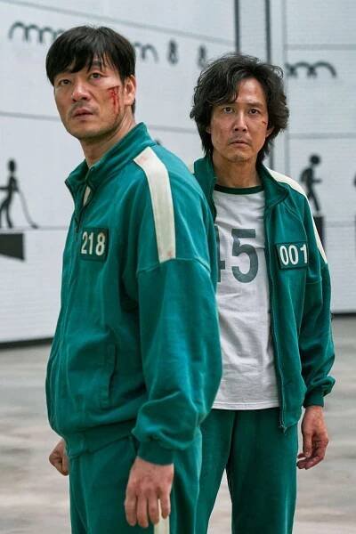 Park Hae-soo as Cho Sang Woo and Lee Jung-jae as Seong Gi-hun in Season 1 of Squid Game.