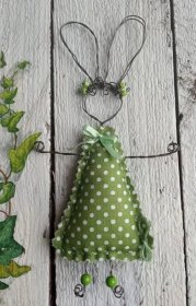 a green and white christmas tree decoration hanging on a wall