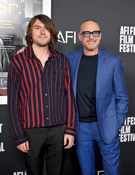 Robert Downey Jr. stands with his arm around his son, Indio Downey.