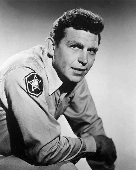 circa 1962: Portrait of American actor Andy Griffith leaning forward and wearing his sheriff's costume from the television series, 'The Andy Griffith Show'.