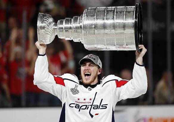 T.J. Oshie lifting the Stanley Cup.
