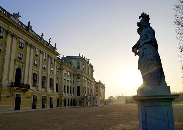 a statue in front of a large building