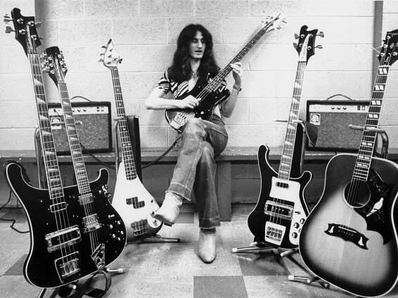 UNITED STATES - MAY 01:  USA  Photo of Geddy LEE and RUSH, Geddy Lee posed, backstage with guitar collection on All The World's A Stage tour  (Photo by Fin Costello/Redferns)