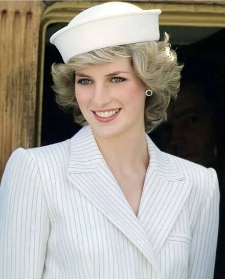 a woman wearing a sailor's hat in front of a window